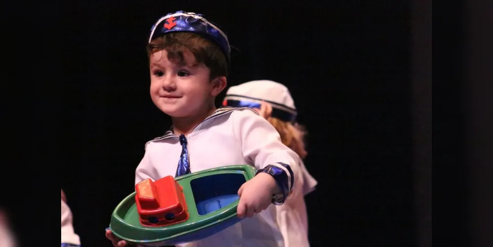 Otávio Francisco Fioravante, filho de Luiza Saad Francisco Diego Augusto Fioravante, vestido de marinheiro em uma apresentação especial.