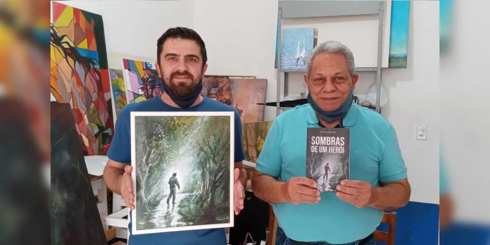 Eduardo Urba Neto ao lado de Sidney Mariano, respectivamente escritor e artista da ilustração da obra: "Sombras de um Herói".